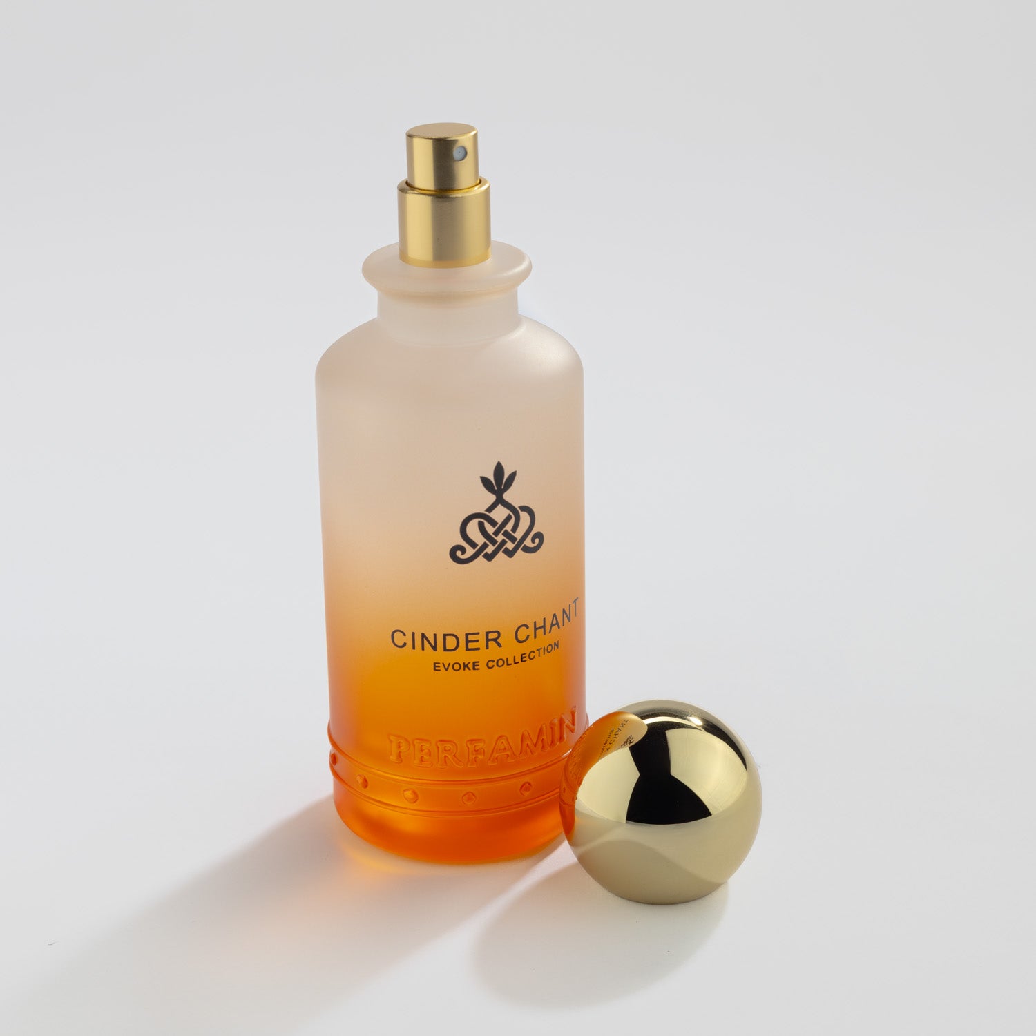 Cinder Chant cologne bottle with the gold cap removed showing the spray nozzle.