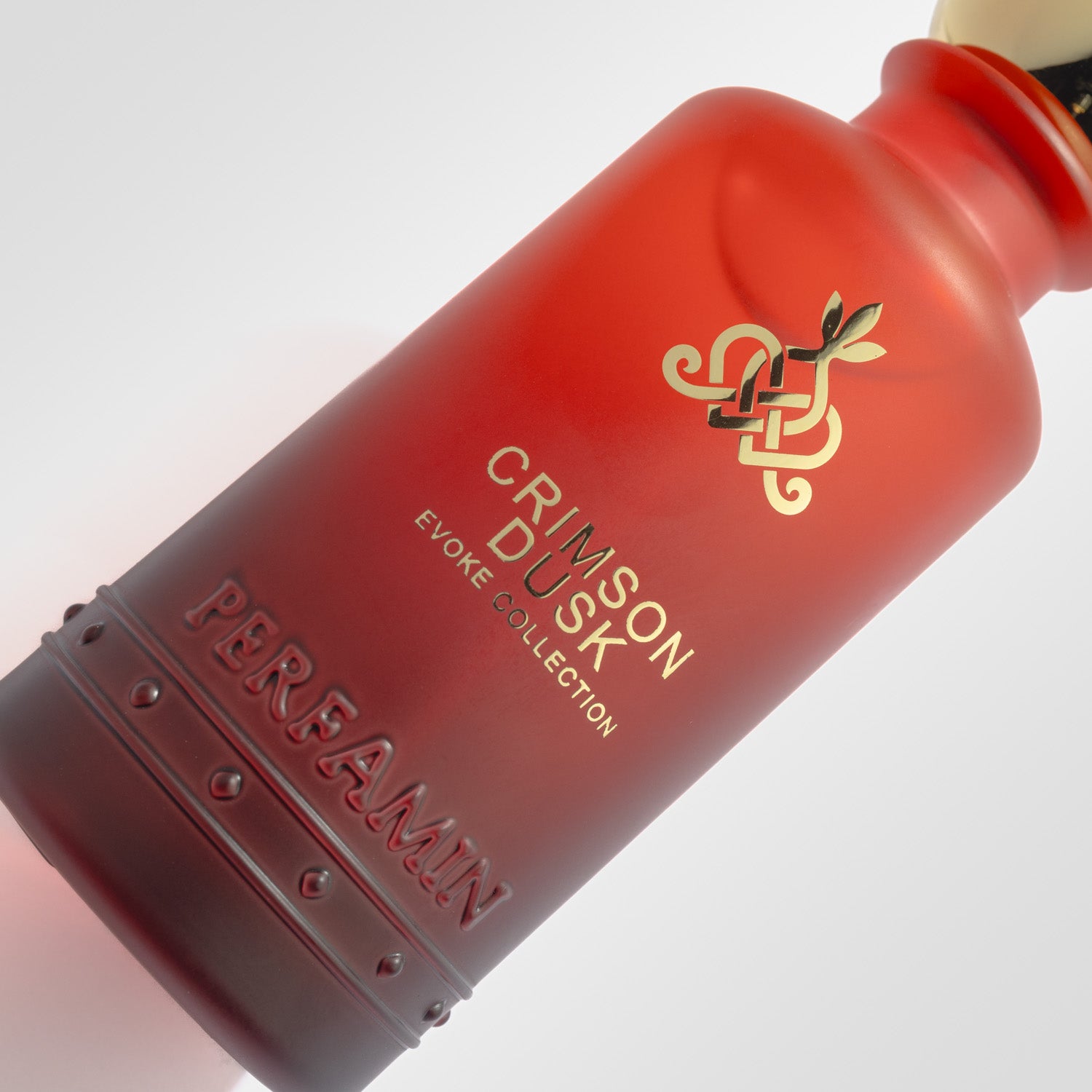 Close-up of Crimson Dusk Perfamin perfume bottle with feminine romantic gourmand scent profile