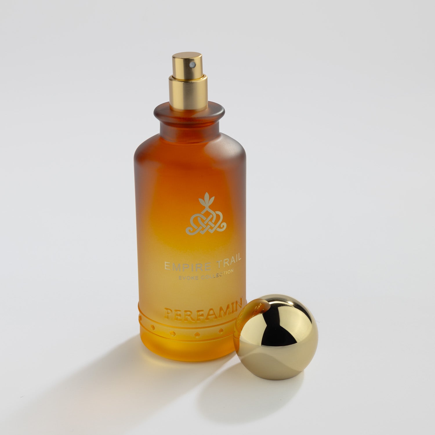 Empire Trail Eau de Parfum bottle with gold atomizer and Perfamin branding