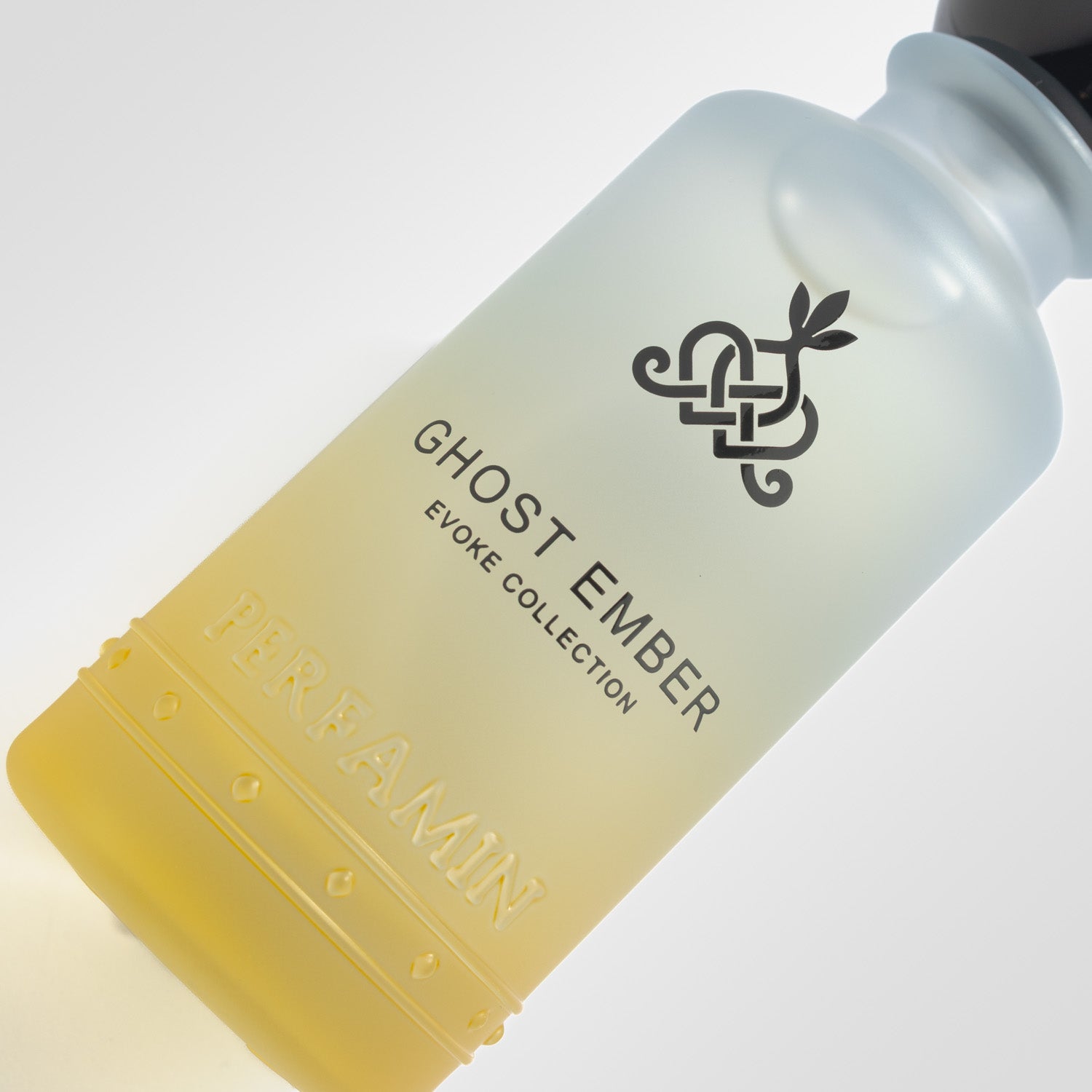 Close-up of Ghost Ember Perfamin perfume bottle with unisex amber woody scent profile