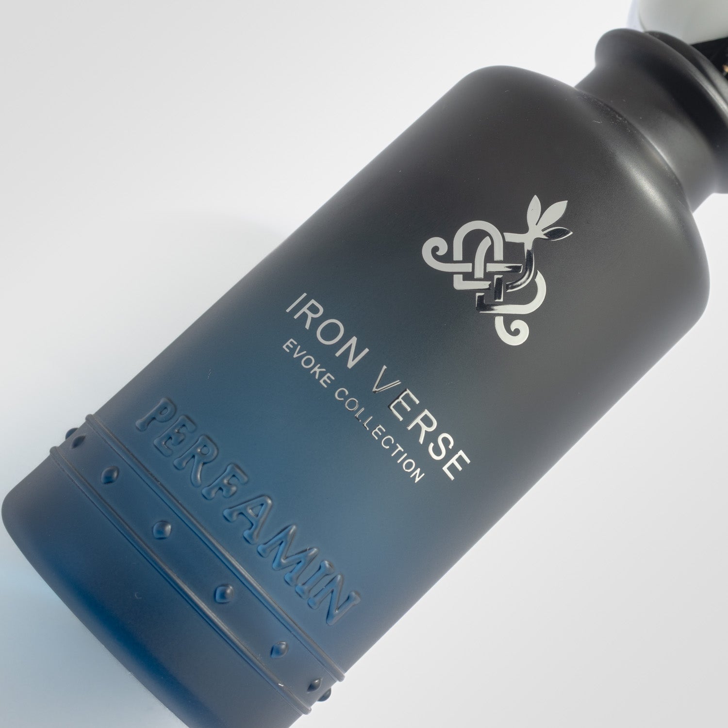 Close-up of Iron Verse Perfamin perfume bottle with masculine woody amber scent profile
