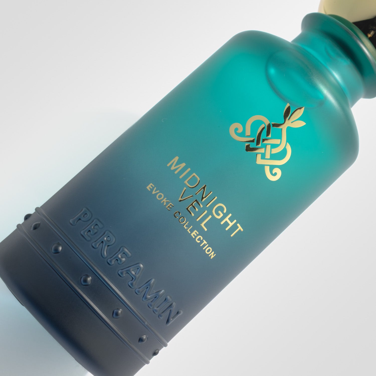 Close-up of Midnight Veil Perfamin perfume bottle with dark woody amber scent profile