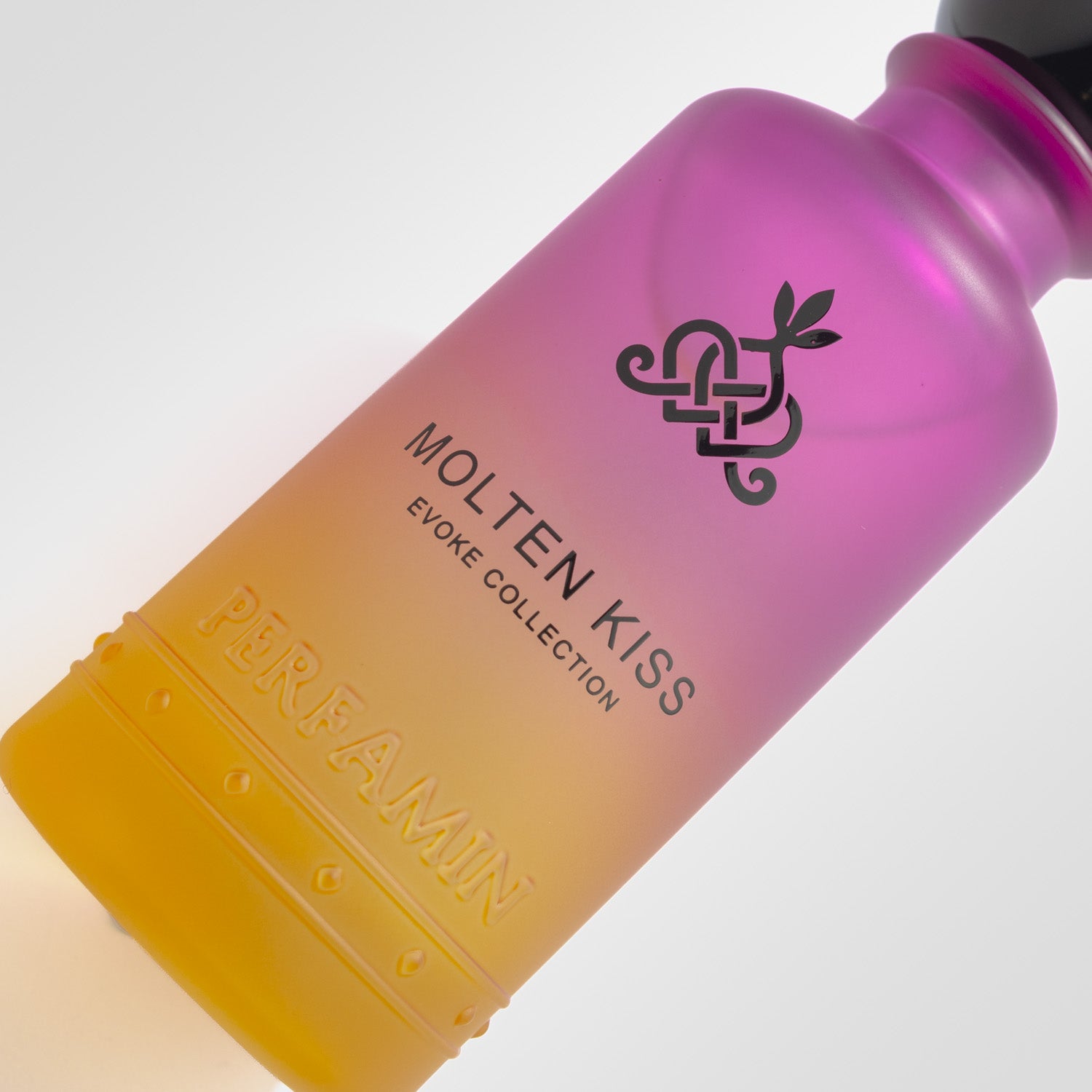 Close-up of Molten Kiss Perfamin perfume bottle with warm honey vanilla gourmand scent profile