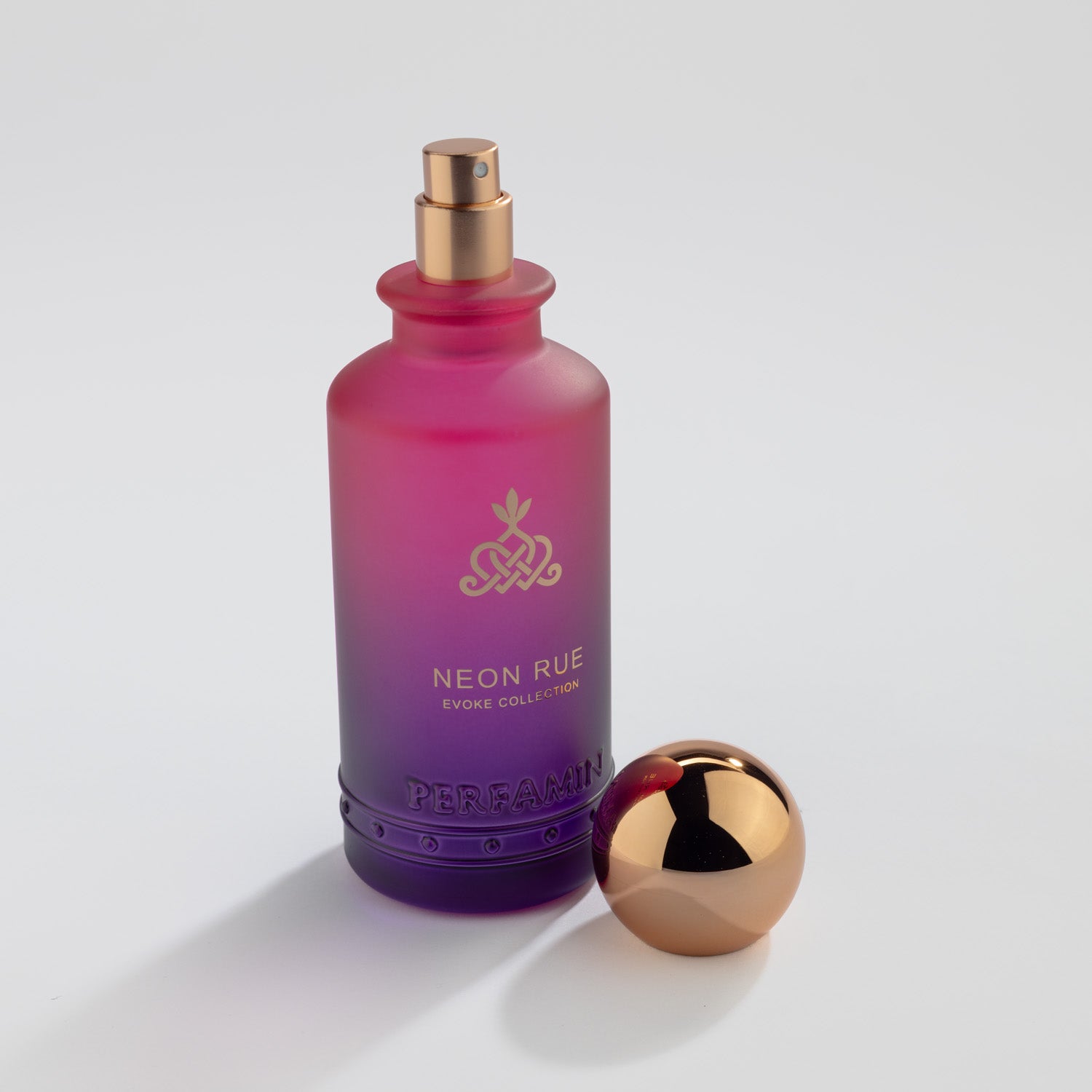Neon Rue Eau de Parfum bottle with gold atomizer and Perfamin branding