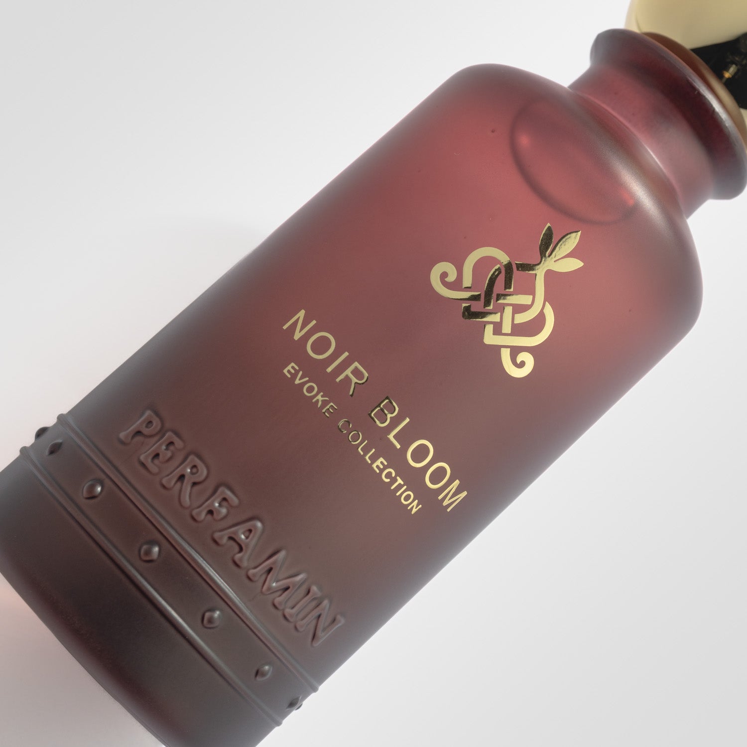 Close-up of Noir Bloom Perfamin perfume bottle with dark gourmand floral scent profile