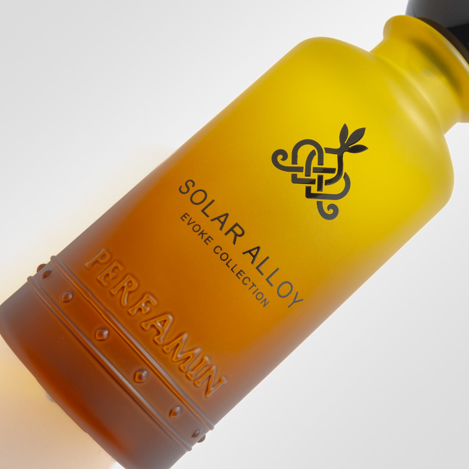 Close-up of Solar Alloy Perfamin perfume bottle with masculine amber woody scent profile