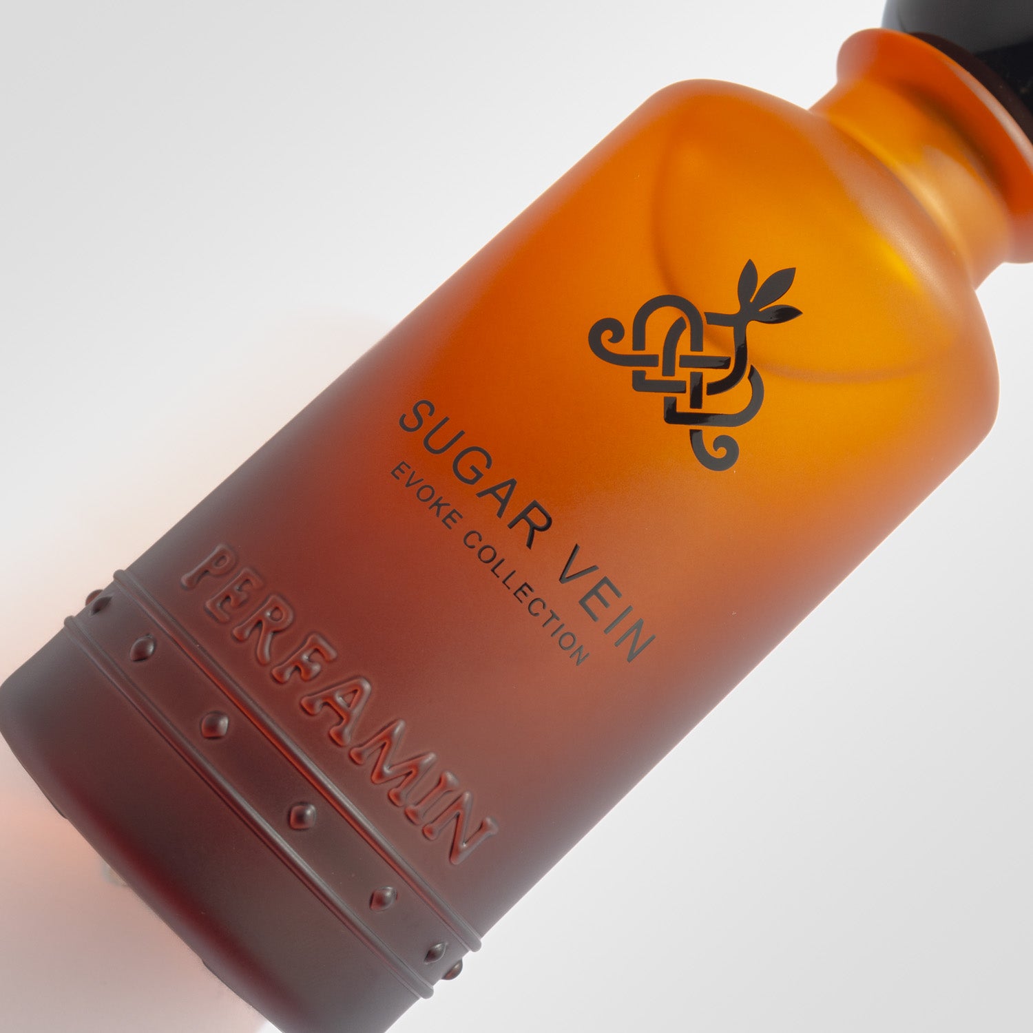 Close-up of Sugar Vein Perfamin perfume bottle with feminine gourmand scent profile